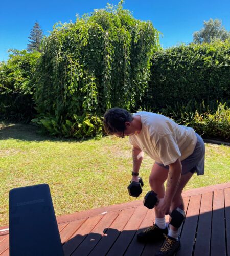 Personal trainer demonstrating a dumbbell row